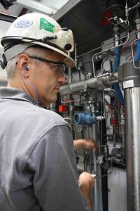 Fluid Aire Dynamics employee inspecting equipment