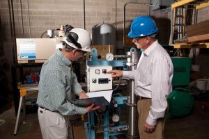 Fluid Aire Dynamics employees working on an air system
