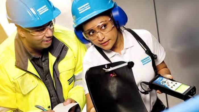 Two workers servicing an air system