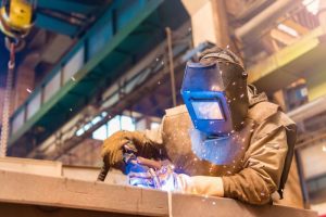 Image of man welding wearing protective gear